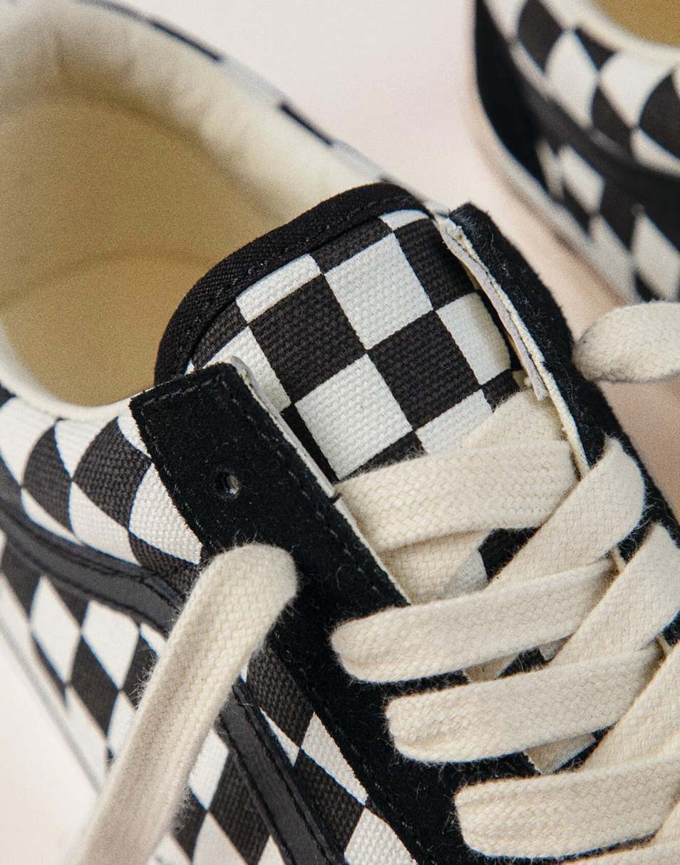 A cheetah print Premium Old Skool Vans shoe tangled in musical cords.