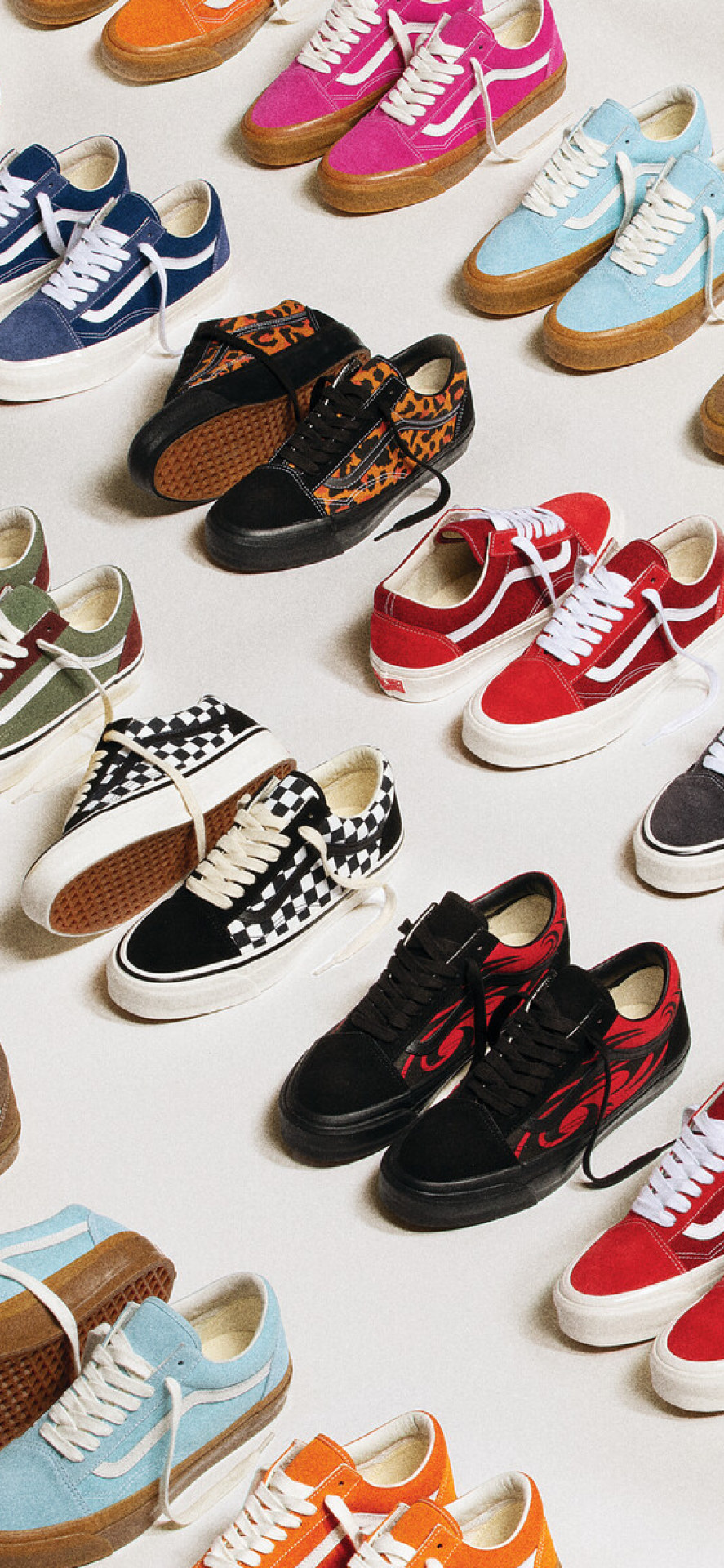Many pairs of the Premium Old Skool Music Collection laid out on a floor in four colorways.